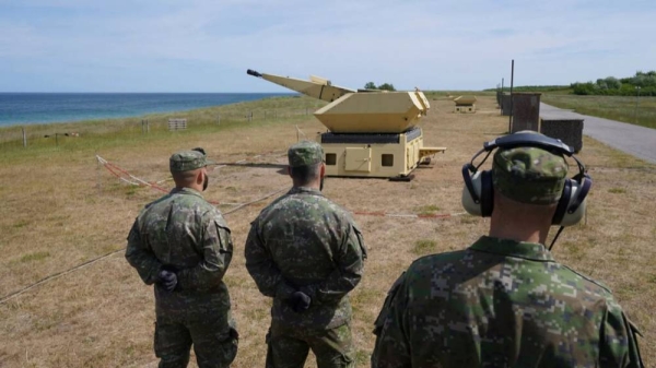 Slovakian soldiers stand by a gun of the Mantis (Modular, Automatic and Network Capable Targeting and Interception System) air defense weapon system