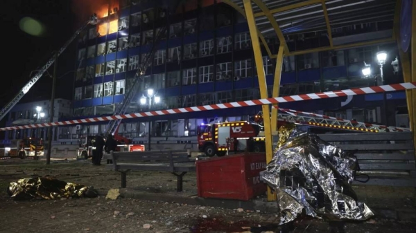 Dead bodies of people killed in a Russian airstrike are seen at a tram station in Zaporizhzhia, Ukraine, Wednesday Jan. 8, 2025