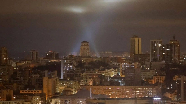 Ukrainian service personnel use searchlights as they search for drones in the sky over the city during a Russian drone strike, amid Russia's attack on Ukraine, in Kyiv, Ukraine on January 13, 2025