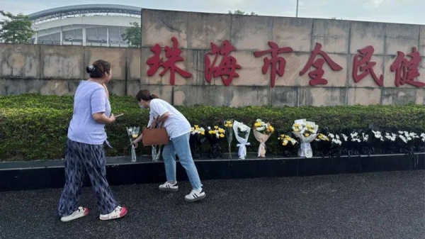 People placed flowers outside the stadium in Zhuhai after the attack