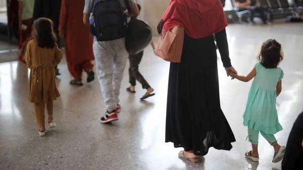 Refugees arrive at Dulles International Airport in Dulles, Virginia, after being evacuated from Kabul following the Taliban takeover of Afghanistan on August 27, 2021