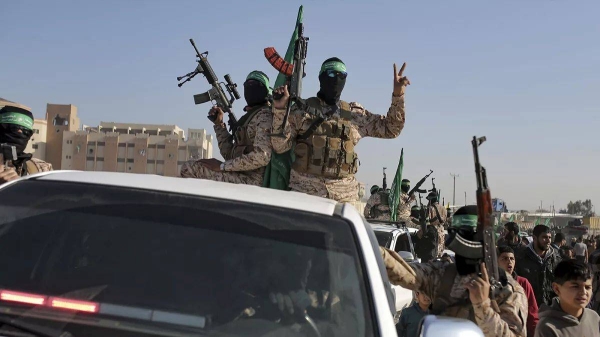 A crowd greets Islamic Jihad and Hamas fighters as they arrive for the hand-over of Ihostages to the Red Cross in the south Gaza Strip town of Khan Younis, 30 January 2025