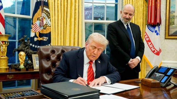 President Donald Trump signs executive actions in the Oval Office on Feb. 10, 2025