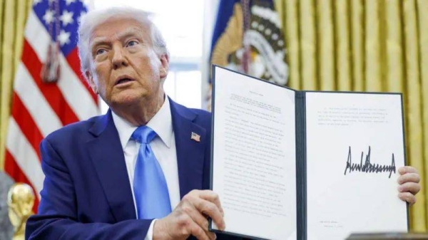 Trump shows an executive order he has just signed