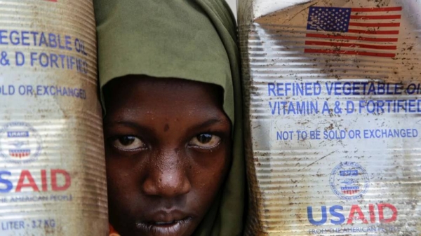 A Somali internally-displaced person (IDP) child looks out from her family's makeshift home in Maslah camp on the outskirts of Mogadishu, on 5 February 2025