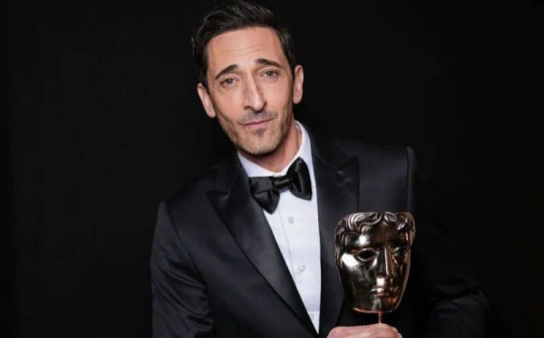 Adrien Brody reacts after winning the best actor award