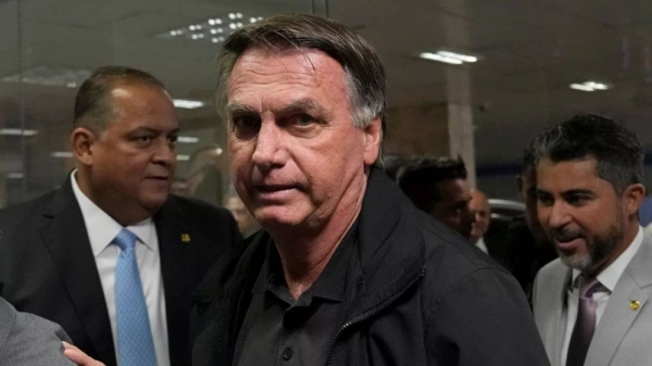 Former Brazilian President Jair Bolsonaro arrives for a luncheon with senators from his support base, at the National Congress building in Brasilia, Tuesday, Feb. 18, 2025