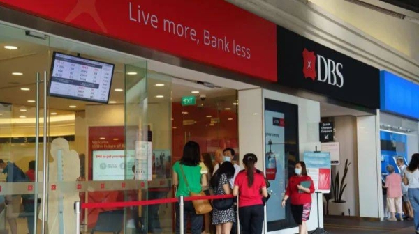 Customers and bank staff outside a DBS branch in Singapore, on 5 August, 2024