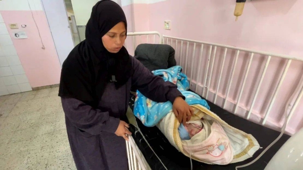 A mother tends to her two-month-old baby, Yousaf, a hypothermia patient at Nasser Hospital, southern Gaza, on February 25. Doctors urged Israel to allow more fuel and shelter supplies into the enclave