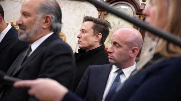 Elon Musk attends a meeting with President Donald Trump in the Oval Office at the White House on February 13, in Washington, DC