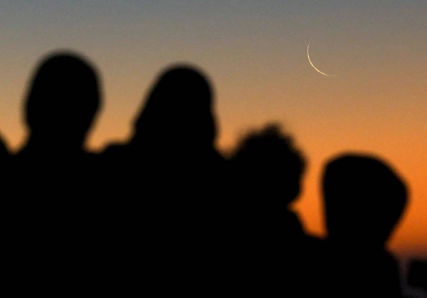 Muslims look at the sighting of the crescent moon on Sea Point promenade in Cape Town, South Africa, on March 11, 2024