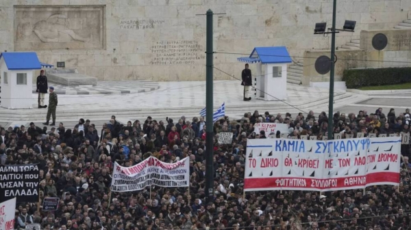 Protesters gather in front of the parliament in central Athens, Greece to mark two years since a deadly rail disaster, Friday, Feb. 28, 2025