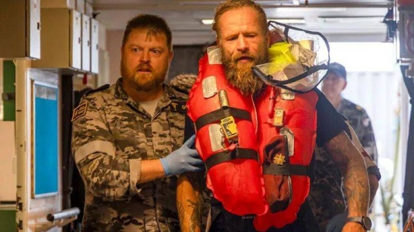 Aurimas Mockus (R) sounded a distress signal late on Friday because of a cyclone