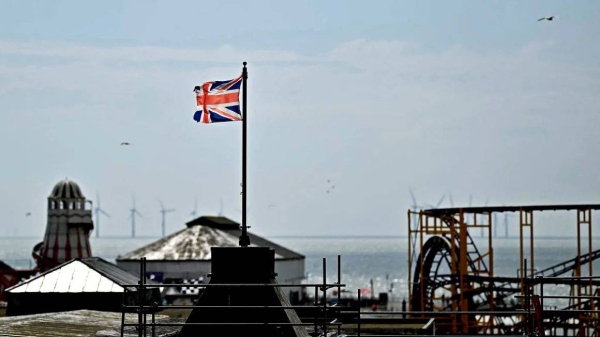 A Union Jack flag flies from a pole above Clacton Pier in Clacton-on-Sea, eastern England, on June 4, 2024