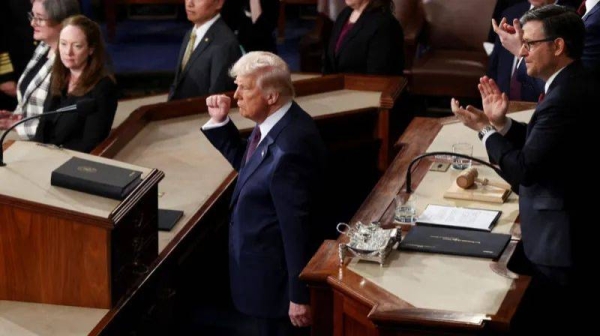 President Trump is seen in an aerial view in the House chamber with his fist in the air