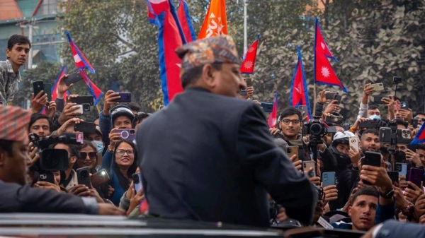 Former King Gyanendra Shah of Nepal waves upon his arrival at Tribhuvan International Airport in Kathmandu, Nepal, on Sunday, March 9, 2025