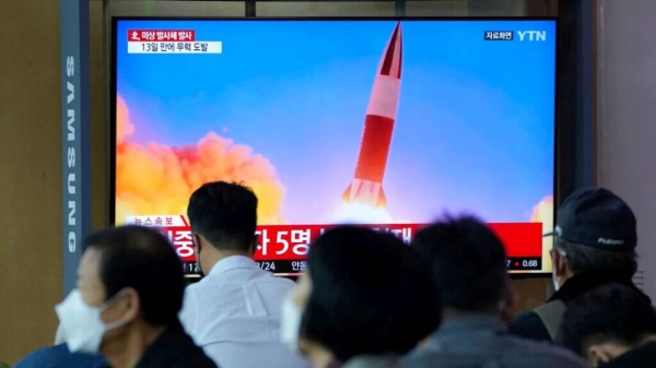 FILE- People watch a TV showing a file image of North Korea's missile launch during a news program at the Seoul Railway Station in Seoul, South Korea, Tuesday, Sept. 28, 2021