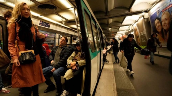 A passenger stands inside a metro train, at the Oberkampf district east of Paris, France