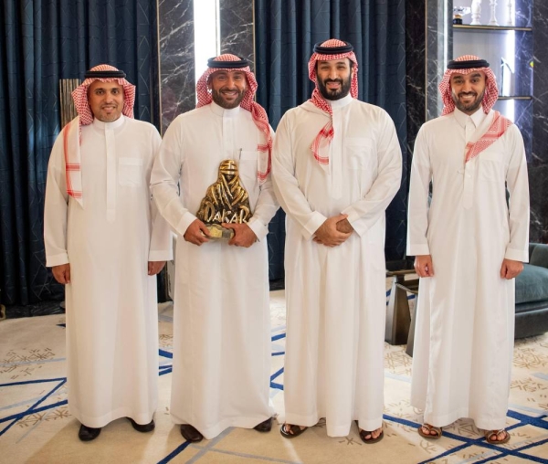 Saudi Crown Prince and Prime Minister Mohammed bin Salman with Saudi rally driver Yazeed Al-Rajhi, Minister of Sports Prince Abdulaziz bin Turki Al-Faisal, and Prince Khalid bin Sultan Al-Abdullah Al-Faisal, Chairman of the Saudi Automobile and Motorcycle Federation. (SPA)