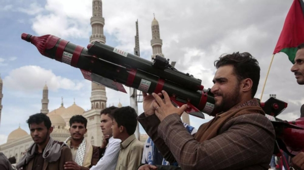 A Houthi supporter holds a mock missile during a protest marking Jerusalem Day in support of Palestinians in the Gaza Strip, in Sanaa, Yemen, April 5, 2024