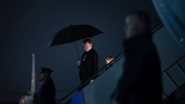 Elon Musk and his son X Æ A-12 step off of Air Force One upon arrival at Joint Base Andrews in Maryland, on March 17