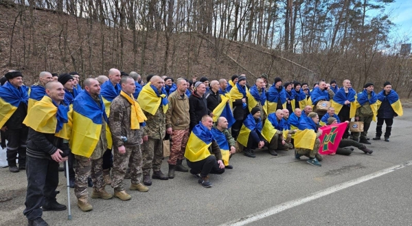 Ukrainian servicemen react after returning from captivity during a POWs exchange between Russia and Ukraine, in Chernyhiv region, Ukraine, Wednesday.