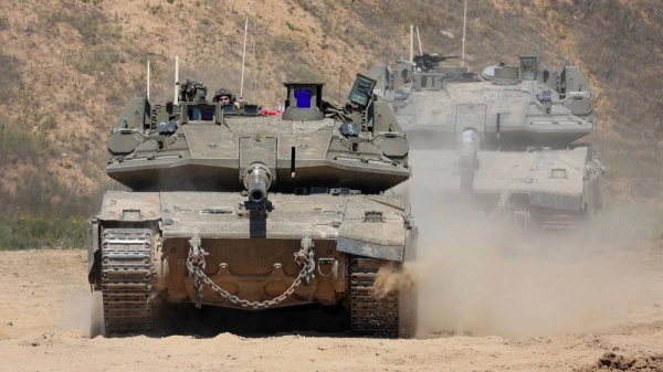 Israeli soldiers operate a tank near the southern border with Gaza on Wednesday