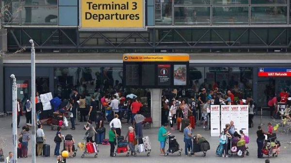 Passengers queue outside Terminal 3 at Heathrow Airport in London (File photo)