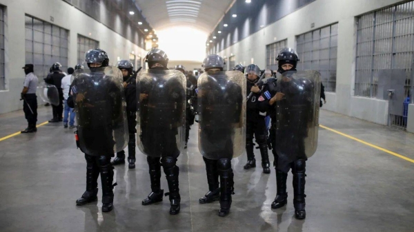 Police officers stand guard during a media tour at the Terrorism Confinement Center (CECOT) prison, in Tecoluca, El Salvador April 4, 2025