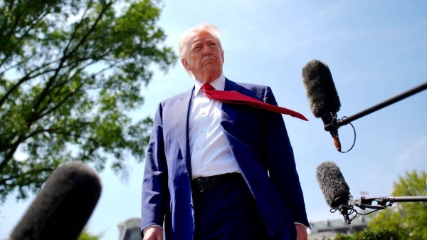 US President Donald Trump speaks to members of the media before boarding Marine One on the South Lawn of the White House on Tuesday in Washington, DC