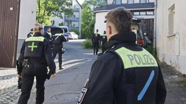 Police officers search buildings following the ban of the Reichsbürger group Kingdom of Germany in Gera, Germany, Tuesday, May 13, 2025