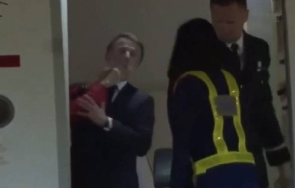 Macron’s office downplays viral video of wife pushing his face during Vietnam arrival