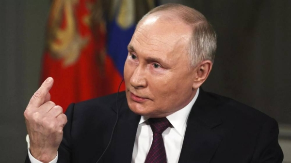 Russian President Vladimir Putin gestures while speaking during an interview