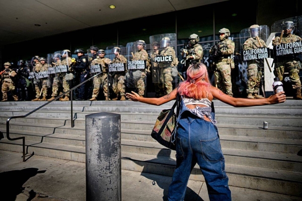 A protester taunts a line of California National Guard standing in front of a federal building in downtown Los Angeles on Monday.