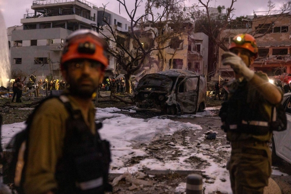 Rescue forces at a building that was hit by ballistic missiles in Tel Aviv, Israel, on Monday.