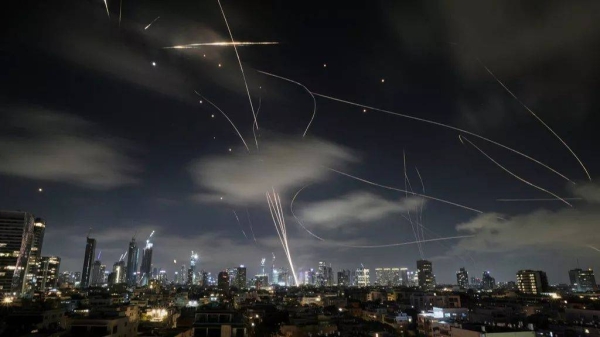 The Israeli Iron Dome air defense system fires to intercept missiles during an Iranian attack over Tel Aviv, Israel, early Wednesday, June 18, 2025