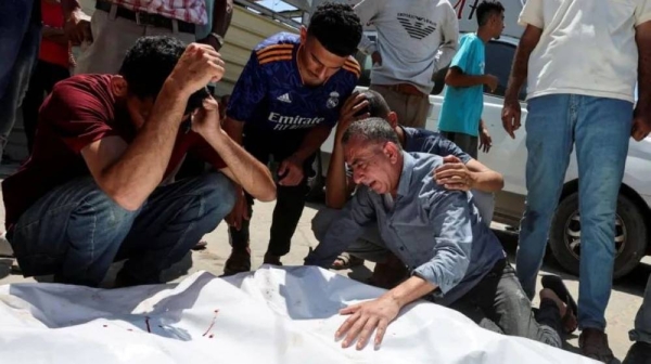 People mourn Palestinians who were killed in an Israeli airstrike in Deir al-Balah.