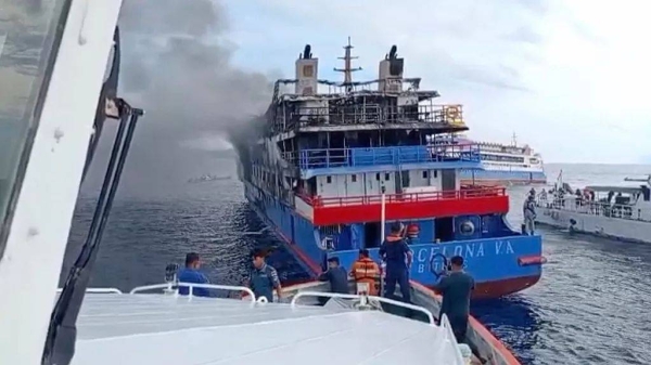 A rescue ship approach passenger ship KM Barcelona after it caught fire in the waters off Talise Island in North Sulawesi, Indonesia, Sunday, July 20, 2025