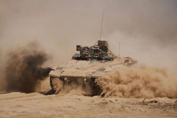 Israeli soldiers drive on their armoured personnel carrier back from inside the northern Gaza Strip into southern Israel, 29 July, 2025