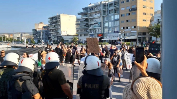 Police face protesters at the port of Volos