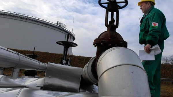 Istvan Szekeres, engineer of the Hungarian Oil and Gas Company (MOL) checks the receiving area of the Druzhba oil pipeline in the country's largest oil refinery in Szaz