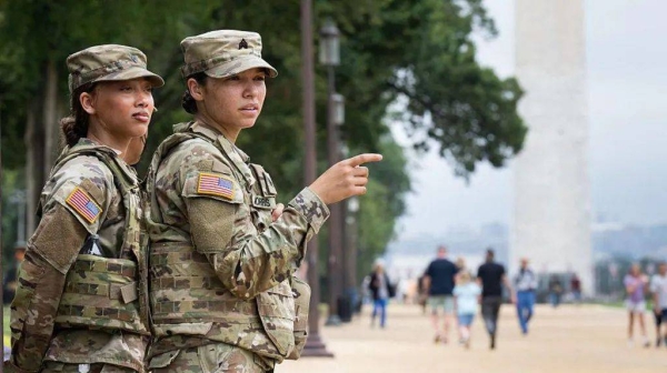 Two female members of the National Guard patrol on the National Mall near the US Capitol in Washington
