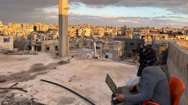 Manar submitted one of her applications on top of a damaged building in Rafah, southern Gaza, in February 2025