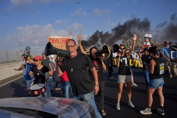 Activists block a highway during a protest demanding the immediate release of hostages held by Hamas in Gaza, 26 August, 2025