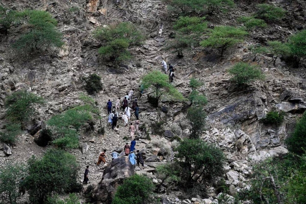 Residents from surrounding towns and villages climb as they try to reach the quake-hit region to assist survivors in the Nurgol district, 2 September, 2025