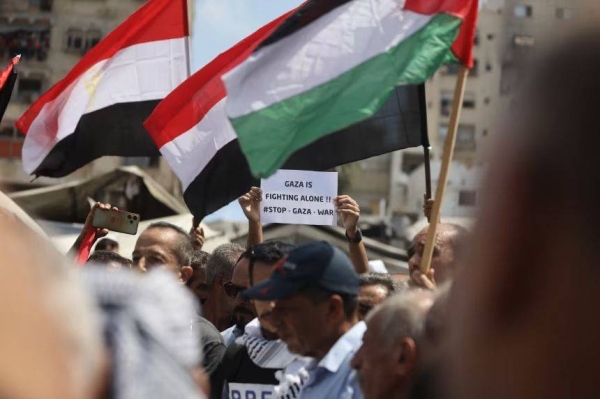 Palestinians gather in the Al-Rimal neighborhood to demand an end to Israeli attacks and forced displacement in Gaza City, Gaza, on August 21, 2025