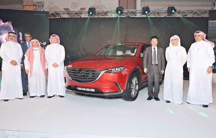 Sheikh Ali Hussein Alireza, CEO of Haji Husein Alireza & Co. Ltd, with other company and Mazda officials pose beside the all-new CX-9