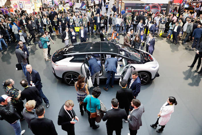 People gather around the Faraday Future's FF91 electric car at CES International Thursday (Jan. 5, 2017), in Las Vegas. — AP