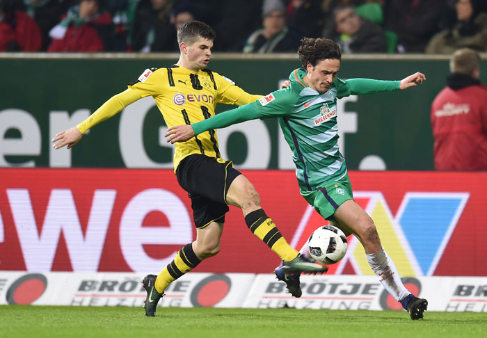 Bremen's midfielder Thomas Delaney (R) and Dortmund's midfielder Julian Weigl vie for the ball during the Bundesliga football match in Bremen on Saturday. — AFP