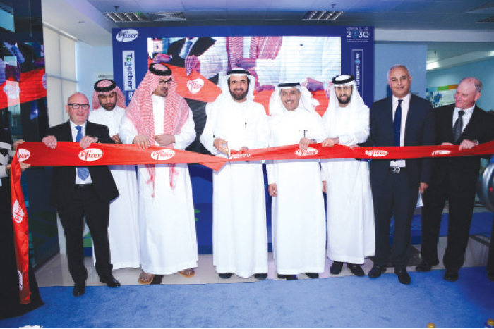 Dr. Tawfiq Bin Fawzan Al Rabiah, Saudi Minister of Health, cuts the ceremonial ribbon during the formal opening of Pfizer Saudi Ltd manufacturing facility in King Abdullah Economic City